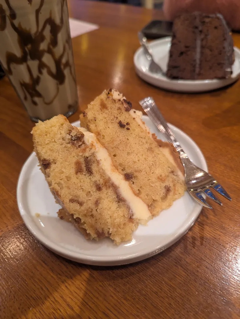 A slice of layered sponge cake with a creamy drink
